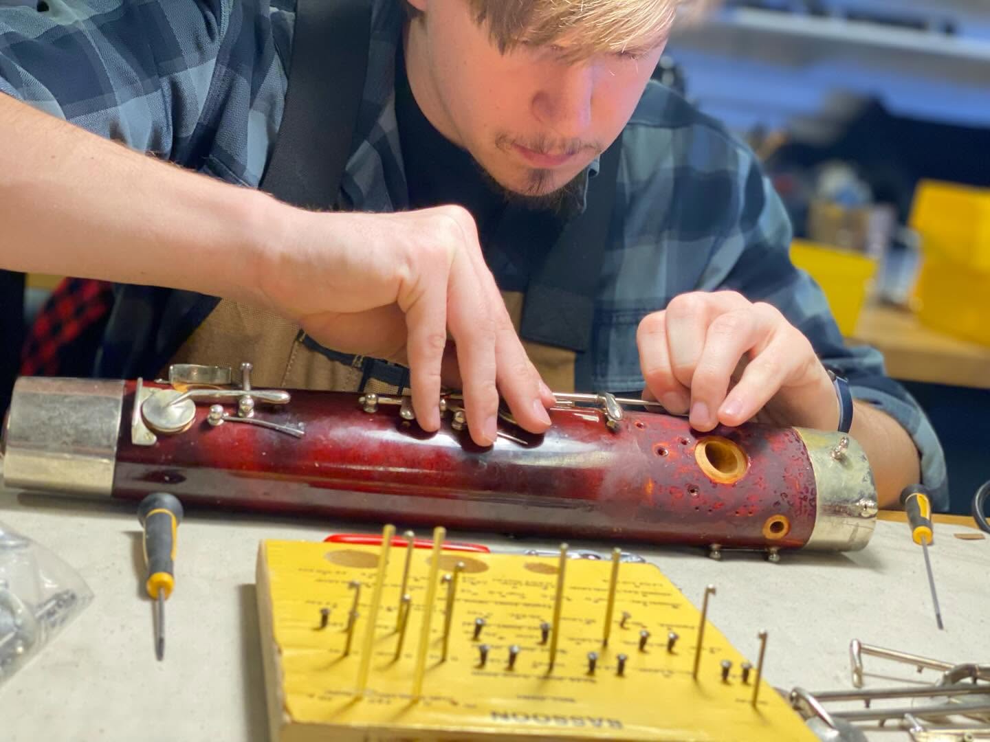 Harrison repairing a bassoon.